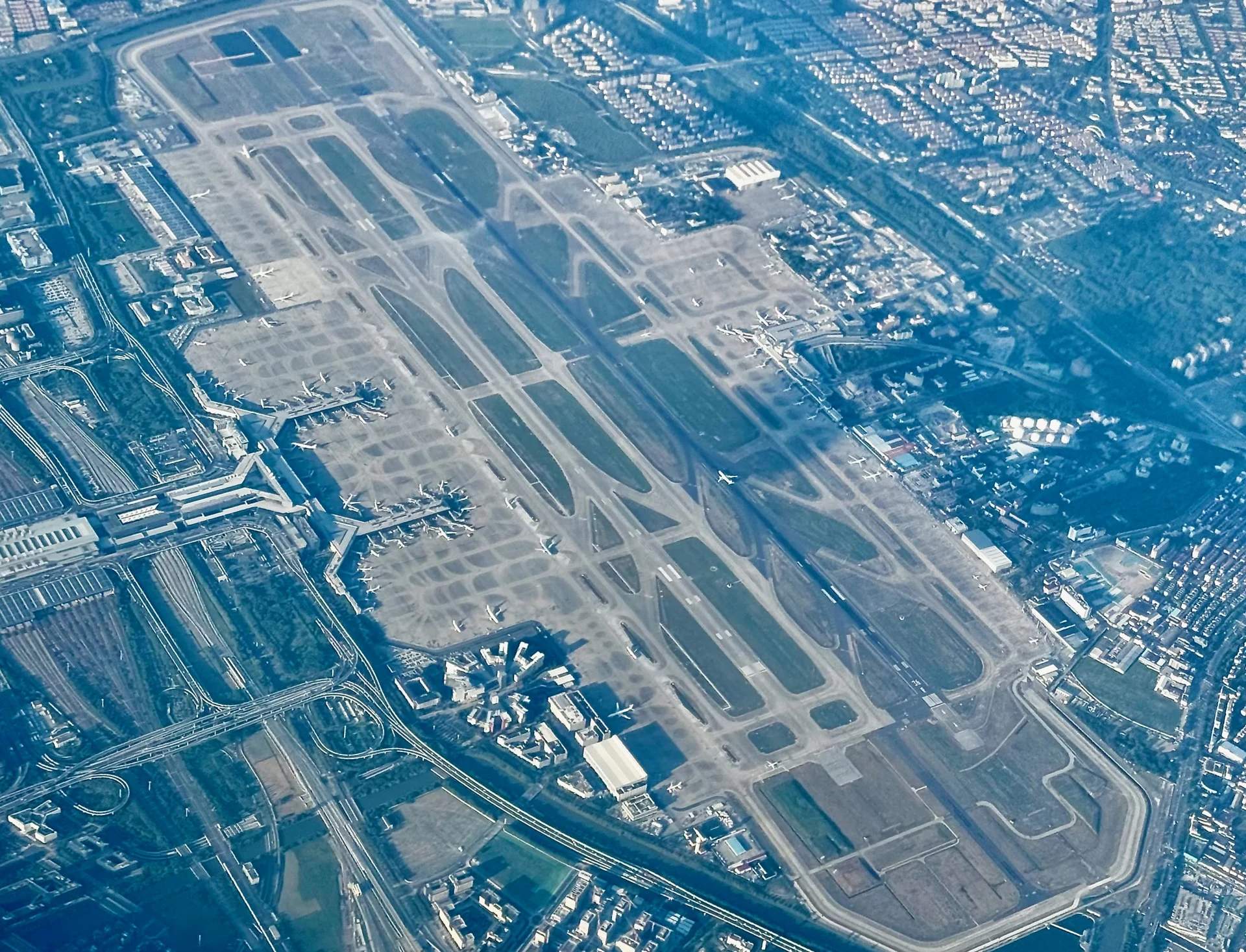 Aerial view of Shanghai Hongqiao Airport, with its terminals, aircraft and parallel runways